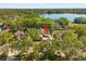 An aerial view of a single Gathering home, surrounded by mature trees and a large lake in the background at 780 Old Mount Dora Rd, Eustis, FL 32726