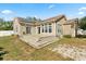 Home's backyard showing a deck, sliding doors, and solar panels on the roof at 780 Old Mount Dora Rd, Eustis, FL 32726