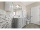 Elegant bathroom with mosaic tile backsplash and a gray vanity with drawers at 780 Old Mount Dora Rd, Eustis, FL 32726