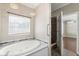 Bright bathroom with a soaking tub, pendant lighting, and tile surround at 780 Old Mount Dora Rd, Eustis, FL 32726