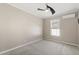 Cozy bedroom with carpet flooring, ceiling fan, and a window providing natural light at 780 Old Mount Dora Rd, Eustis, FL 32726