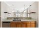 View of the kitchen with stainless steel appliances, and sink, and a view into the living room at 780 Old Mount Dora Rd, Eustis, FL 32726