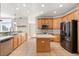 Well-lit kitchen features stainless steel appliances, wood cabinets, and an island with a light countertop at 780 Old Mount Dora Rd, Eustis, FL 32726