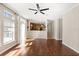 Bright and airy living room featuring wood floors, ceiling fan, and sliding glass doors leading to the outside at 780 Old Mount Dora Rd, Eustis, FL 32726