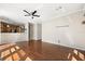 Open-concept living space with hardwood floors, a view into the kitchen area, and ample natural light at 780 Old Mount Dora Rd, Eustis, FL 32726