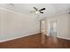 Spacious main bedroom with hardwood floors, ceiling fan, and an en-suite bathroom with a view of the toilet at 780 Old Mount Dora Rd, Eustis, FL 32726