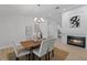 Dining area with wood table, chandelier, and view of fireplace and open floor plan at 822 Swaying Palm Dr, Apopka, FL 32712