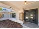 Welcoming entryway featuring a modern, multi-paneled door, brick pillar, and stylish overhead lighting at 822 Swaying Palm Dr, Apopka, FL 32712