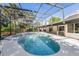 Relaxing screened pool area featuring a spa, spacious deck, and serene backyard views at 822 Swaying Palm Dr, Apopka, FL 32712