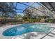 Beautiful screened pool with spa, surrounded by lush landscaping and ample deck space for entertaining at 822 Swaying Palm Dr, Apopka, FL 32712