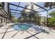 Inviting screened pool and spa, offering a private oasis with easy access to the home's interior at 822 Swaying Palm Dr, Apopka, FL 32712