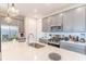 Well-lit kitchen featuring a quartz countertop island, stainless steel appliances, and ample cabinet space at 844 Driving Range Ct, Reunion, FL 34747