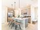 Modern kitchen with stainless steel appliances, a quartz island, and pendant lighting at 844 Driving Range Ct, Reunion, FL 34747