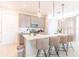 A well-lit kitchen with a central island, bar seating, and stainless steel appliances at 844 Driving Range Ct, Reunion, FL 34747