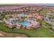 Aerial view of the community resort pool, splash pad, clubhouse, and golf course at 9033 Hazard St, Davenport, FL 33896