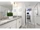 Stylish bathroom with double sinks, granite countertop, and a glass-enclosed shower for a modern feel at 9033 Hazard St, Davenport, FL 33896