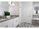 Bright bathroom featuring double sinks, granite countertops, and a soaking tub with tile surround at 9033 Hazard St, Davenport, FL 33896