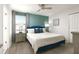 Bedroom featuring gray wood flooring and a blue paneled accent wall at 9033 Hazard St, Davenport, FL 33896