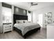 Cozy bedroom with a tufted headboard, neutral bedding, a ceiling fan, and lots of natural light at 9033 Hazard St, Davenport, FL 33896