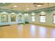 Spacious fitness room with hardwood floors, ceiling fans, and mirrored walls at 9033 Hazard St, Davenport, FL 33896