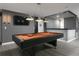 Modern game room featuring a black pool table, stylish lighting, and a sleek separation accent at 9033 Hazard St, Davenport, FL 33896