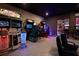 Finished basement with an arcade-style game room, complete with multiple machines and seating at 9033 Hazard St, Davenport, FL 33896