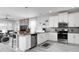 Modern eat-in kitchen featuring white cabinetry, granite countertops, and stainless steel appliances at 9033 Hazard St, Davenport, FL 33896