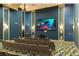 Community movie theater with comfortable seating, large screen, projector, and ambient lighting at 9033 Hazard St, Davenport, FL 33896