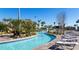 The community lazy river pool has lounge chairs for soaking up the sun, tropical landscaping, and shallow areas at 9033 Hazard St, Davenport, FL 33896