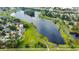 Aerial view of community lake with walking path and lush landscaping between neighborhoods at 908 Jade Forest Ave, Orlando, FL 32828