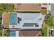 Aerial view of a home featuring a screened pool, solar panels, and a well-maintained roof at 908 Jade Forest Ave, Orlando, FL 32828