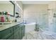 Bright bathroom featuring a freestanding tub, a glass-enclosed shower, and a marble countertop vanity at 908 Jade Forest Ave, Orlando, FL 32828