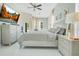 Bright bedroom with white floors, modern furniture, and a ceiling fan at 908 Jade Forest Ave, Orlando, FL 32828