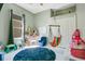 Playful ' bedroom with a hanging hammock chair, a large blue rug, and ample play space at 908 Jade Forest Ave, Orlando, FL 32828