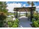 Community gazebo overlooking lake with benches surrounded by lush plants and walking path at 908 Jade Forest Ave, Orlando, FL 32828