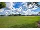 Expansive green field with baseball field in background under a partly cloudy sky at 908 Jade Forest Ave, Orlando, FL 32828