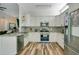 Modern kitchen featuring stainless steel appliances, granite countertops, and wooden floors at 908 Jade Forest Ave, Orlando, FL 32828