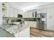 Well-lit kitchen with stainless steel appliances, granite countertops, and white cabinetry at 908 Jade Forest Ave, Orlando, FL 32828