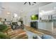 Cozy living room with hardwood floors, comfortable sofas, and an open layout into the kitchen at 908 Jade Forest Ave, Orlando, FL 32828