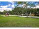 Community playground featuring slides, swings, and play structures surrounded by green space and trees at 908 Jade Forest Ave, Orlando, FL 32828