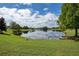 Picturesque pond surrounded by lush green lawn with trees and clear reflections at 908 Jade Forest Ave, Orlando, FL 32828