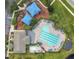 Aerial view of the pool and playground and clubhouse with comfortable lounge chairs and umbrellas at 908 Jade Forest Ave, Orlando, FL 32828