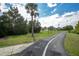 Community walking path with trees, grass, and marked lanes for walkers and bikes at 908 Jade Forest Ave, Orlando, FL 32828