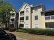 Inviting exterior of a multi-story condo building with well-maintained landscaping and balconies at 1017 S Hiawassee Rd # 3735, Orlando, FL 32835