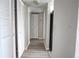 Hallway features vinyl floors, neutral paint, and closet space at 1017 S Hiawassee Rd # 3735, Orlando, FL 32835