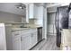 Modern kitchen features stainless steel appliances, white cabinets, and a breakfast bar at 1017 S Hiawassee Rd # 3735, Orlando, FL 32835