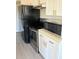 Modern kitchen appliances with white cabinets and gold hardware at 1017 S Hiawassee Rd # 3735, Orlando, FL 32835