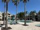 Community pool with palm trees, lounge chairs and tables in a relaxing and inviting atmosphere at 1017 S Hiawassee Rd # 3735, Orlando, FL 32835