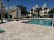 Community pool with tables and chairs, and views of the nearby buildings at 1017 S Hiawassee Rd # 3735, Orlando, FL 32835