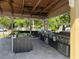 Covered summer kitchen area with multiple grills and a sink for easy outdoor cooking at 1017 S Hiawassee Rd # 3735, Orlando, FL 32835